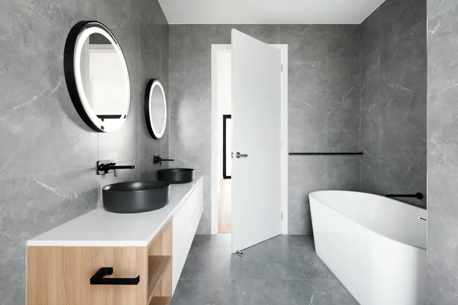 Bathroom remodel in Schertz Tx — gloved hands easing along a crisp finished edge